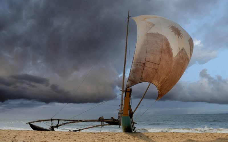 Fishing boats resting on empty beach in Sri Lanka
