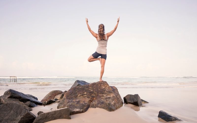 Sri Lanka, Kabalana, young woman practicing yoga on the beach