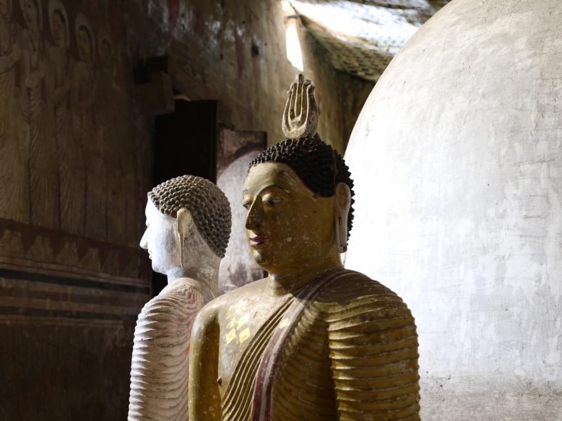 Statues and decorations inside the rock temple in Sri Lanka.