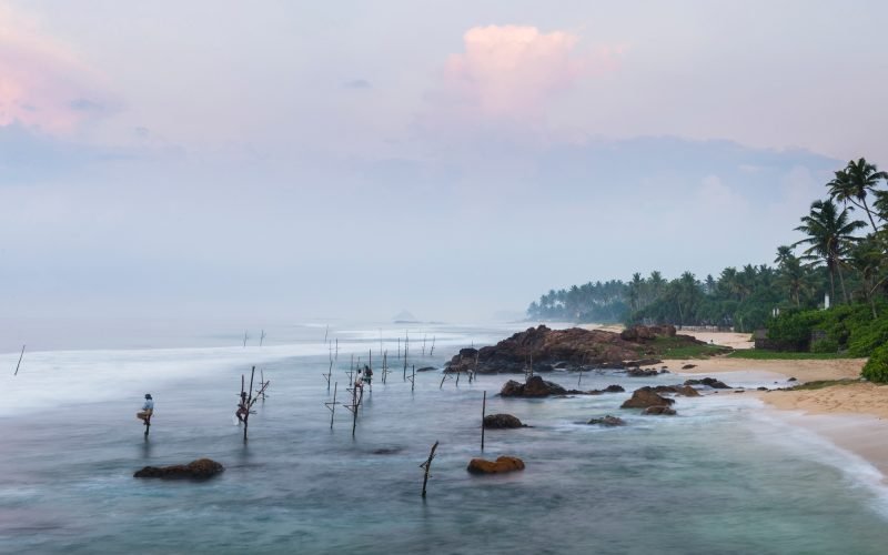 Stilt fishing, stilt fishermen at Midigama Beach, near Weligama, South Coast, Sri Lanka, Asia